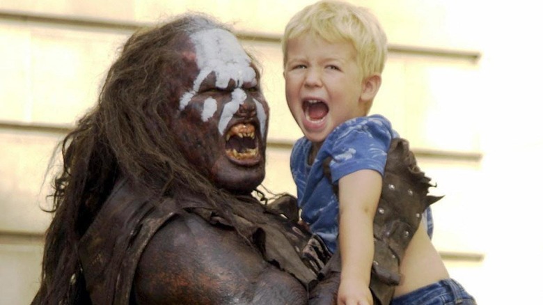 Uruk-hai warrior holding a child