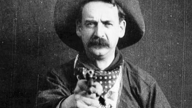 cowboy pointing gun at camera