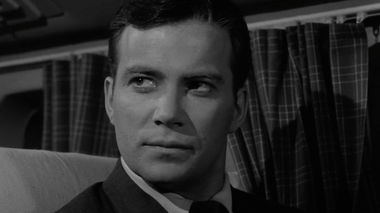 Robert (William Shatner) sits in his plane seat in The Twilight Zone (1959)