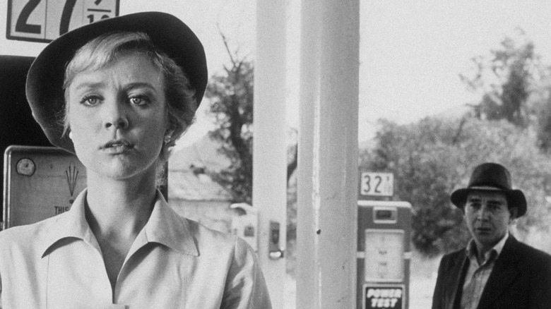 The hitchhiker (Leonard Strong) approaches Nan (Inger Stevens) as a gas station in The Twilight Zone (1959)