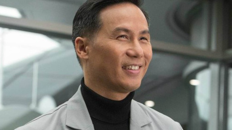 Dr. Henry Wu in a suit and smiling