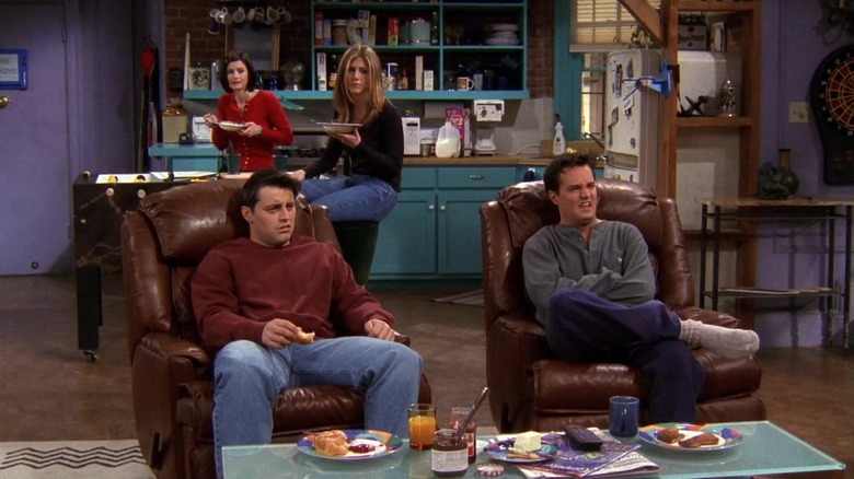 Joey and Chandler watching porn while Monica and Rachel sit behind them on Friends