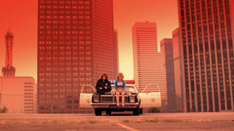 Reggie and Sam sit in the middle of a red DTLA in Night of the Comet