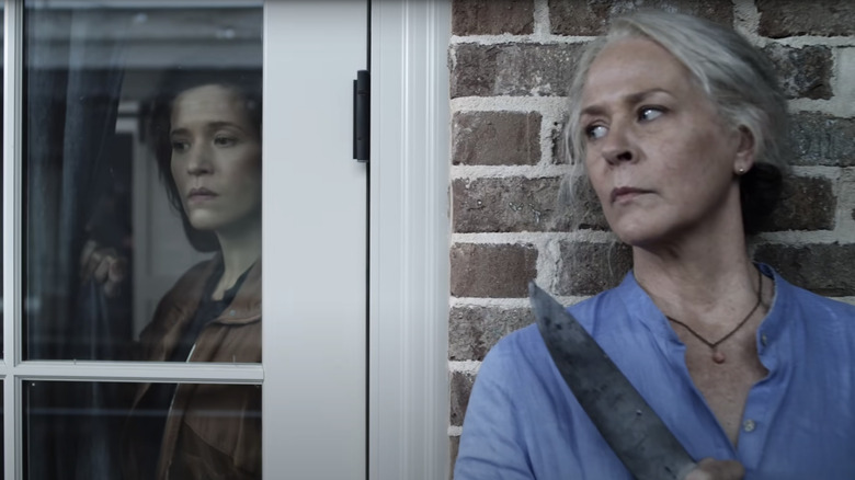 Melissa McBride hiding around the corner in The Walking Dead