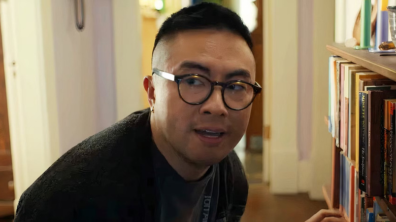 Chris in front of a bookshelf in The Wedding Banquet