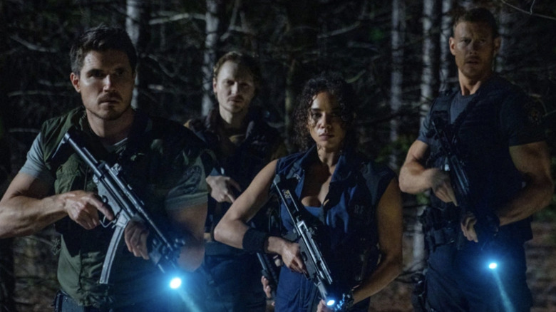 Robbie Amell, Chad Rook, Hannah John-Kamen, and Tom Hopper in Resident Evil: Welcome to Raccoon City