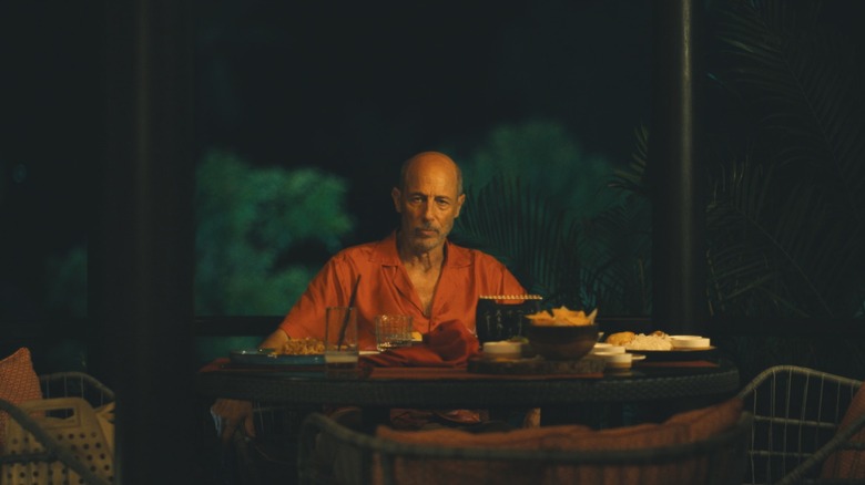 Jon Gries' Gary AKA Greg stares unnervingly across a table where he sits eating alone in The White Lotus