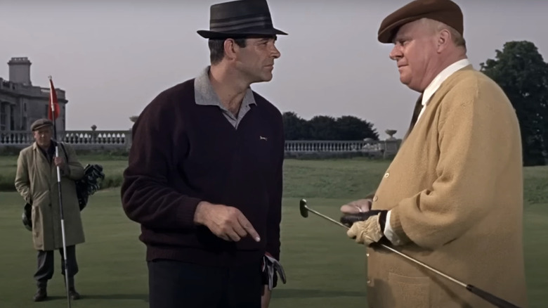 Sean Connery's James Bond converses with Gert Frobe's Auric Goldfinger on the golf course in Goldfinger