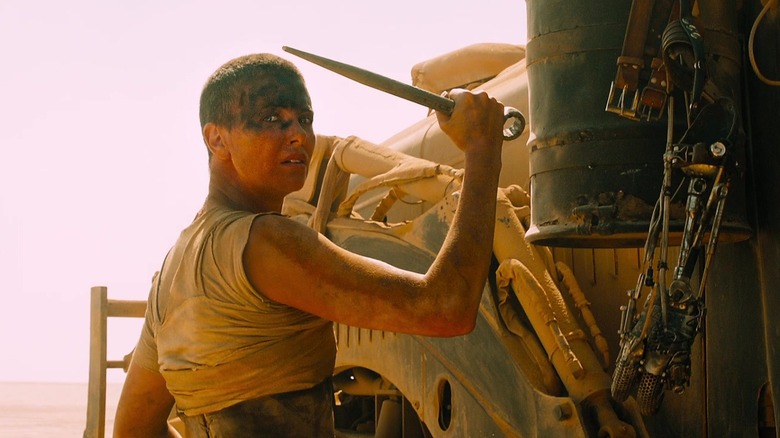 Mad Max Fury Road Furiosa holds metal