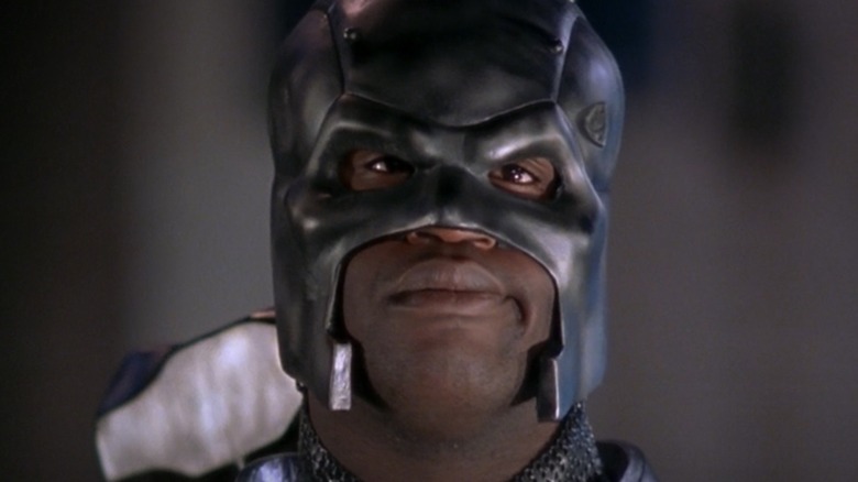 John Henry Ions (Shaquille O'Neal) looks like a surname with a mask that covers a part of steel, like steel