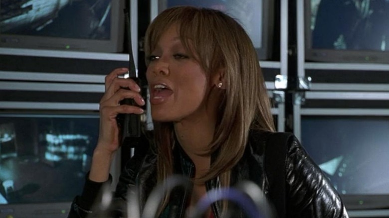 Tyra Banks watches the monitors 