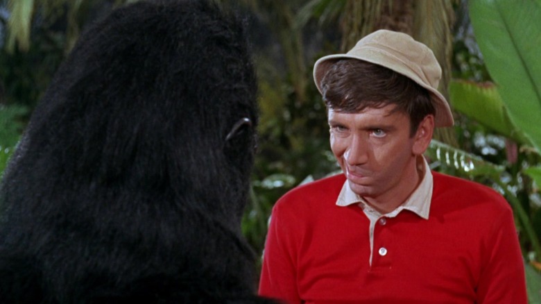 Gilligan making a face at a guy in a ratty gorilla costume