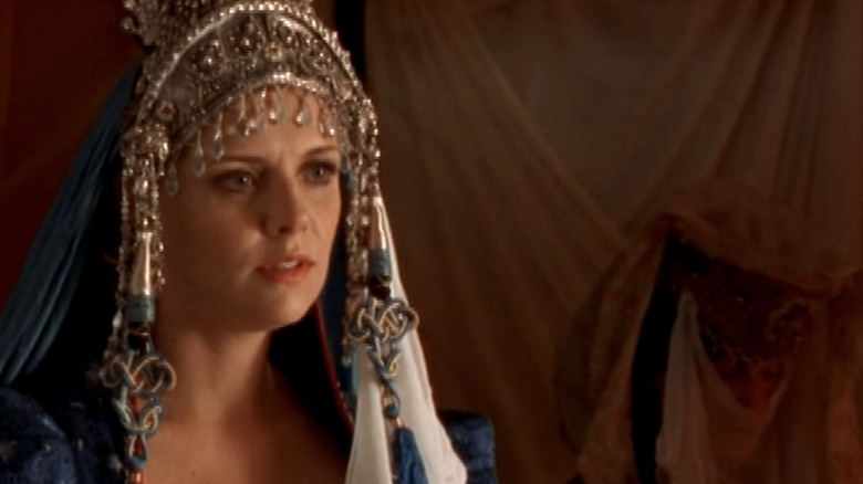 Samantha Carter stands in an outfit she has been forced to wear by a tribe of nomads