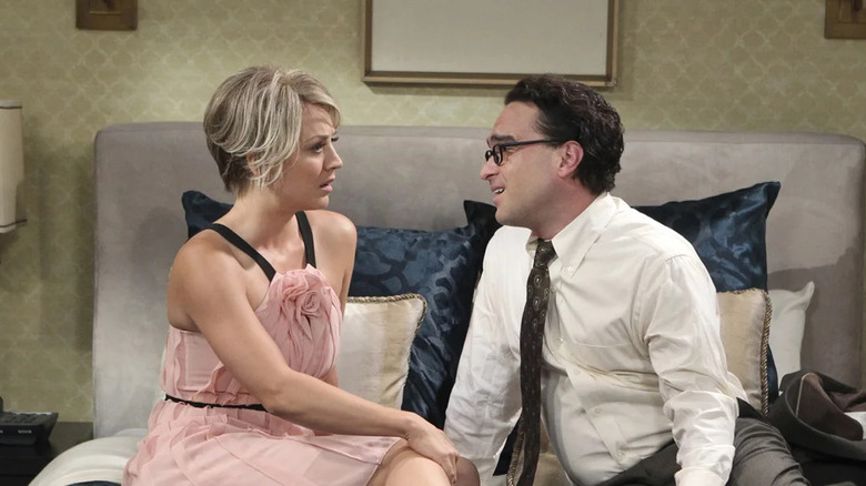 Penny and Leonard sitting on a bed in The Big Bang Theory