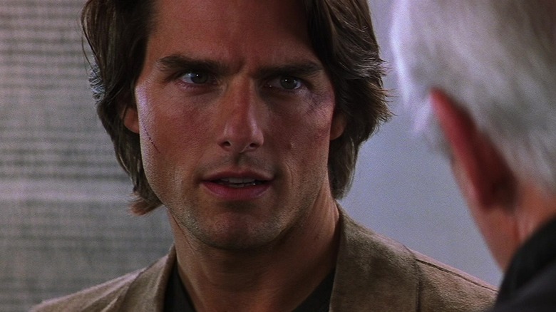 Tom Cruise as Ethan Hunt, long hair, looking intense.