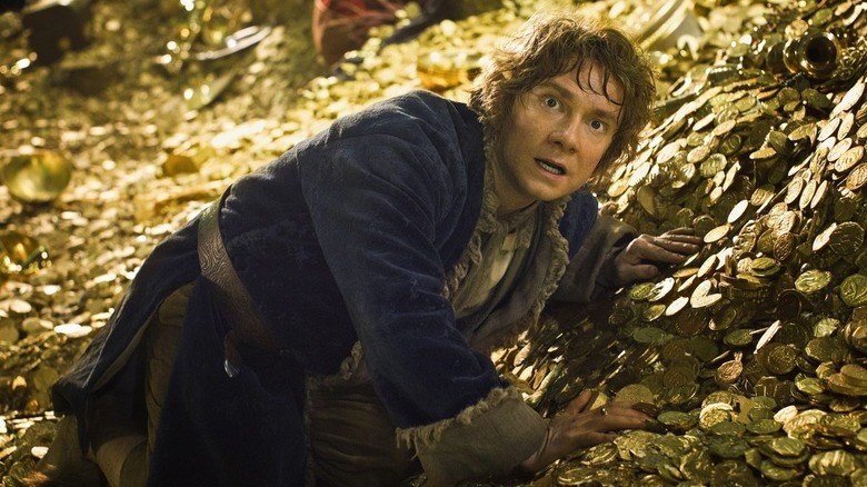 Bilbo on pile of gold in The Hobbit