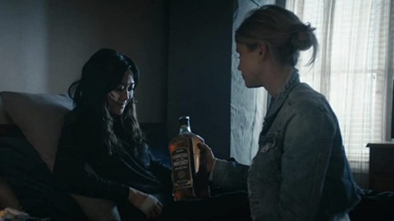 Annie giving Kimiko whiskey