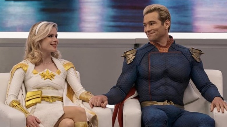 Starlight and Homelander smiling while holding hands