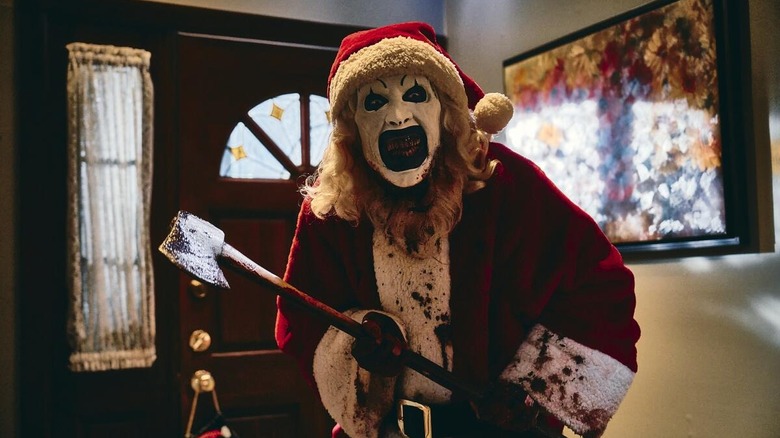 Art the clown dressed as Santa and wielding an axe