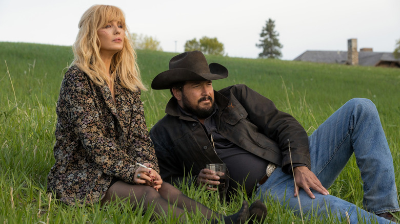 Rip and Beth sitting in a grassy field in Yellowstone