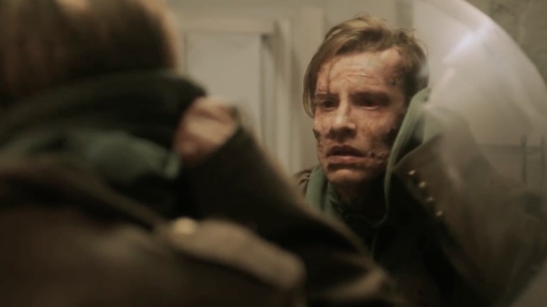 The Monster examines his face in a mirror in the 2015 version of "Frankenstein."