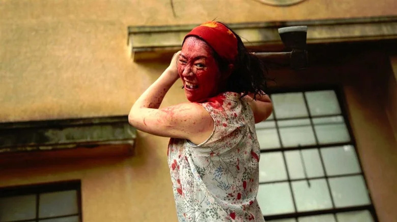 Aika Matsumoto, covered in blood, swinging a hatchet in "One Cut of the Dead."