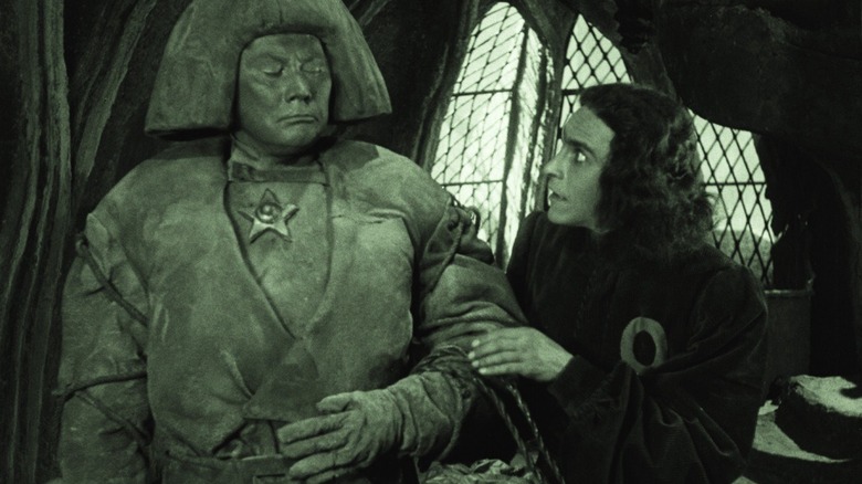 The clay Golem looks at a terrified young man in the 1920 version of "The Golem."