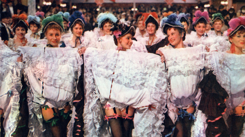 Cancan dancers holding up their skirts in French Cancan