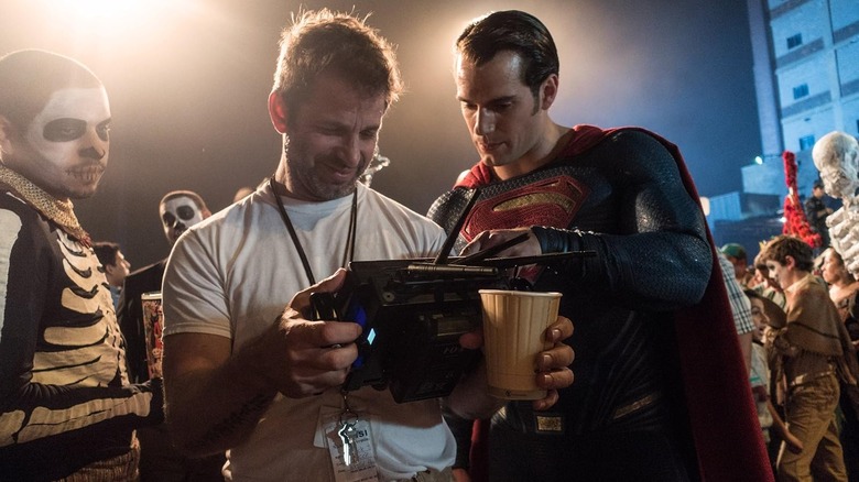 Zack Snyder and Henry Cavill looking over a tablet on the Batman v Superman: Dawn of Justice set