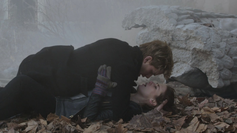 Jeremy Irvine's Daniel Grigori lays on top of Addison Timlin's Lucinda Price in Fallen