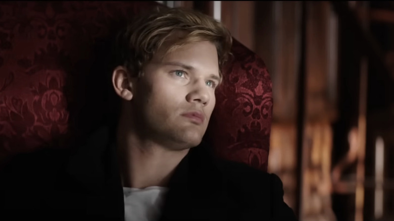 Jeremy Irvine's Daniel Grigori looks up while sitting in a chair in Fallen