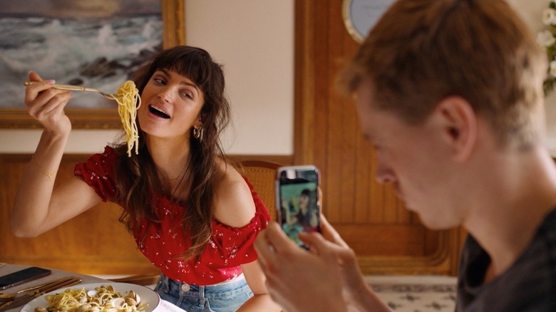 Yaya, posing for an Instagram photo, not eating spaghetti in Triangle of Sadness