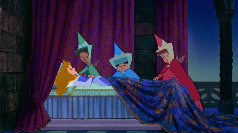 Disney's Sleeping Beauty fairy godmothers looking over sleeping Aurora