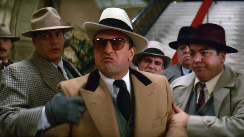 Robert De Niro as Al Capone behind held back in The Untouchables