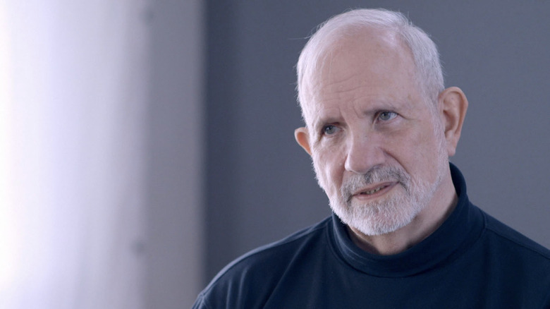 Brian De Palma in a blue turtleneck in an interview for The Criterion Collection