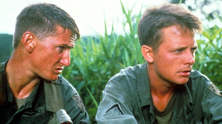 Sean Penn as Meserve and Michael J. Fox as Eriksson huddle in Casualties of War