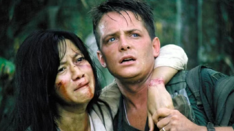 Michael J. Fox as Eriksson tries to take Thuy Thu Le as Oanh home in Casualties of War