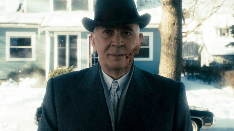 Frank Langella as Arlington Steward standing at the front door in The Box