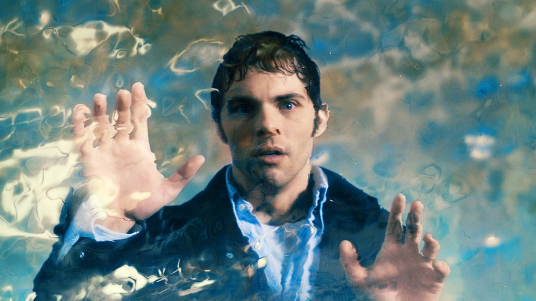 James Marsden as Arthur tapping a transparent dimensional field in The Box