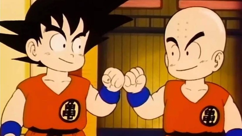 Goku and Krillin fist bumping in Dragon Ball