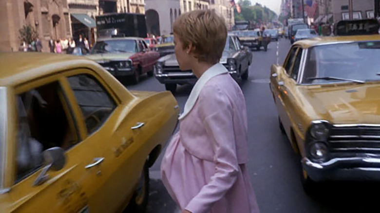 Mia Farrow walking into traffic.