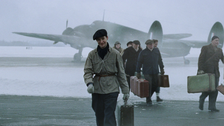 Sue Watn Brean as Gunnar Sanstebi walking from a military transport jet in number 24