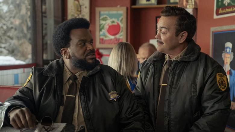 Craig Robinson and Joe Lo Truglio as town sheriffs looking at each other in a diner in Hot Frosty