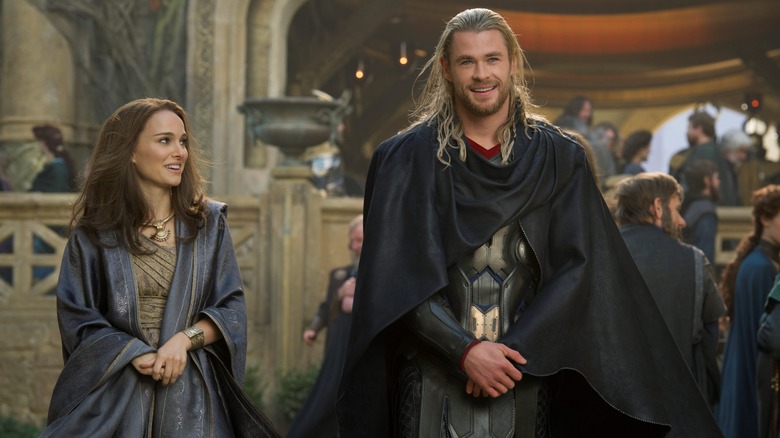 Natalie Portman as Jane Foster happily gazing at Chris Hemsworth as Thor