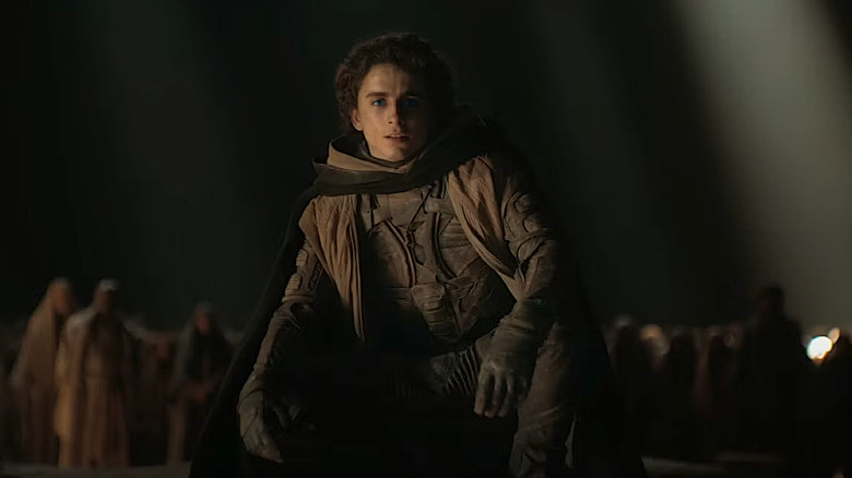 Paul Atreides agachado diante dos Fremen em Dune: Parte Dois