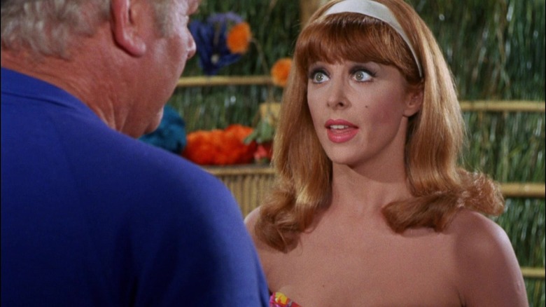 Ginger, her hair down, talking with the Skipper on Gilligan's Island