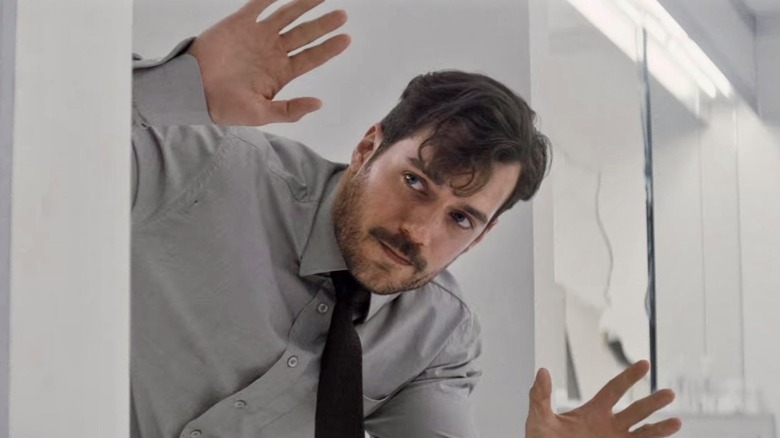 Henry Cavill peeks out of a bathroom stall in Mission: Impossible Fallout