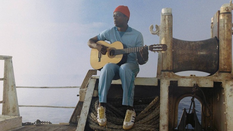 Seu Jorge as Pele Dos Santos plays guitar