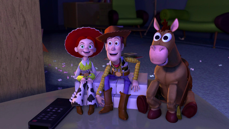 Jessie, Woody, and Bullseye watch TV in Toy Story 2