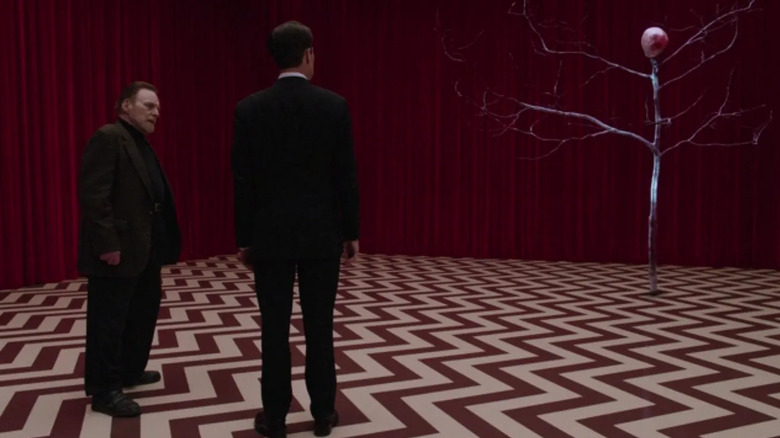 Cooper and the one-armed man look at the arm in Twin Peaks